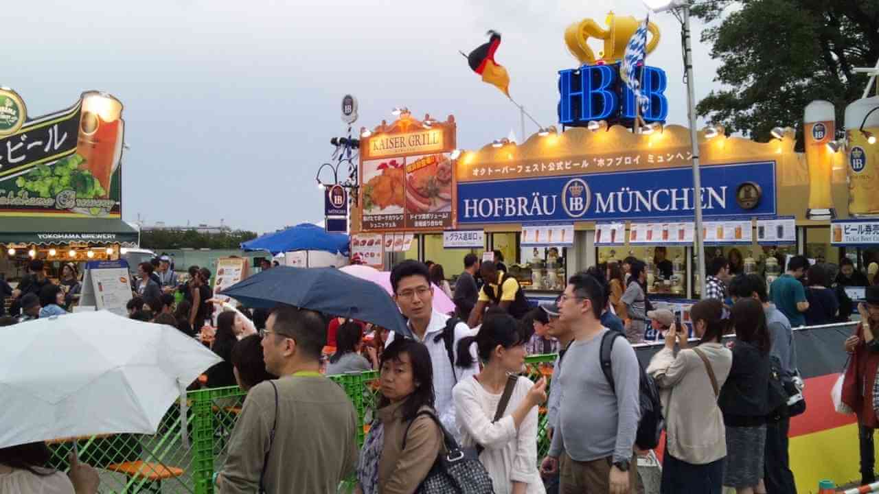 a crowd of people standing under umbrellas in the rain