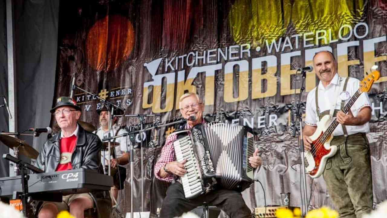 a group of people playing an accordion on stage