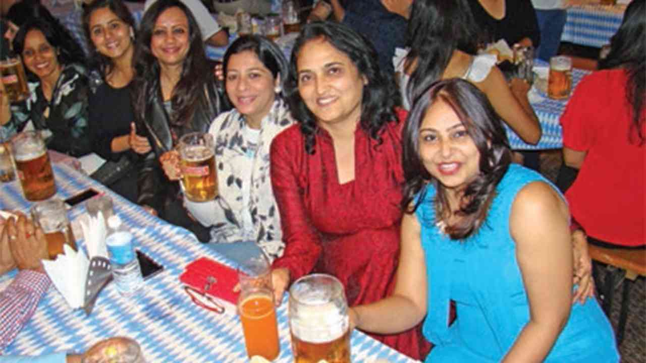 a group of people sitting at a table with drinks