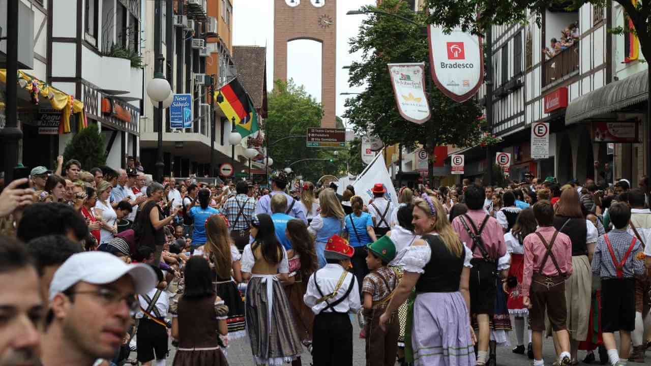 a crowd of people walking down a city street in germany