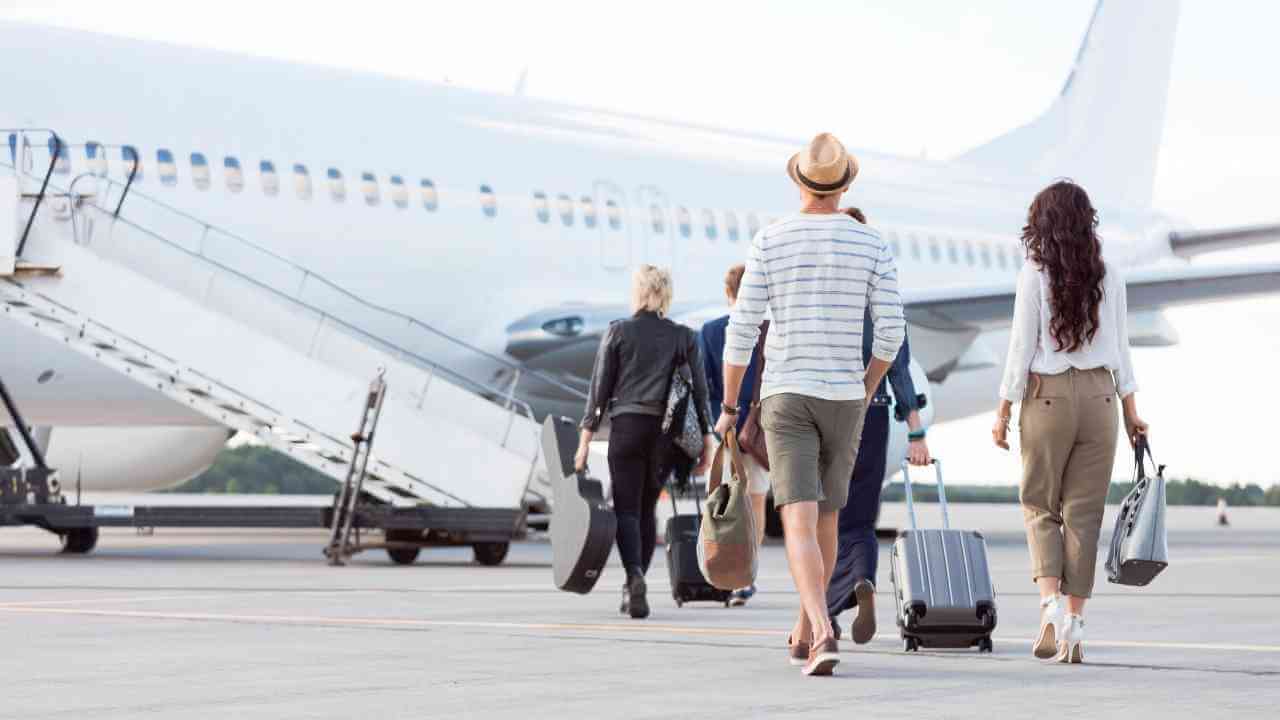 a group of people walking towards an airplane