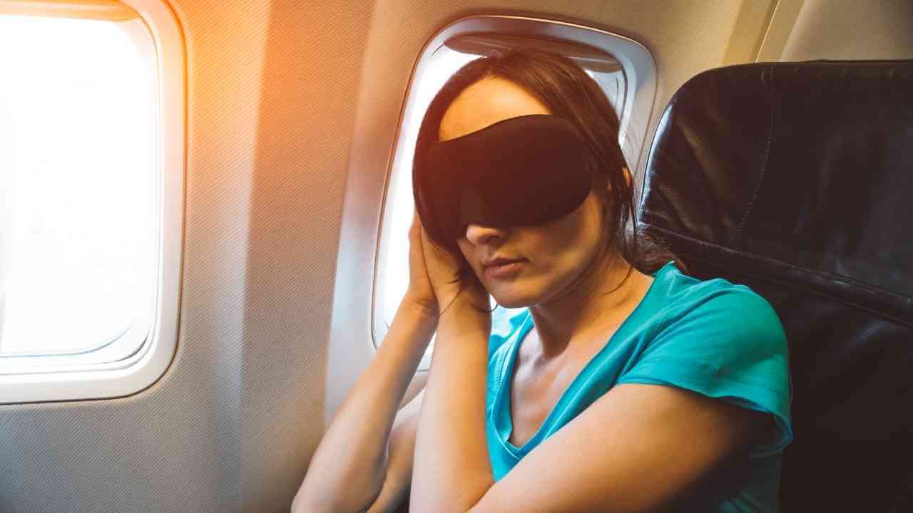 a person wearing a blindfold on an airplane