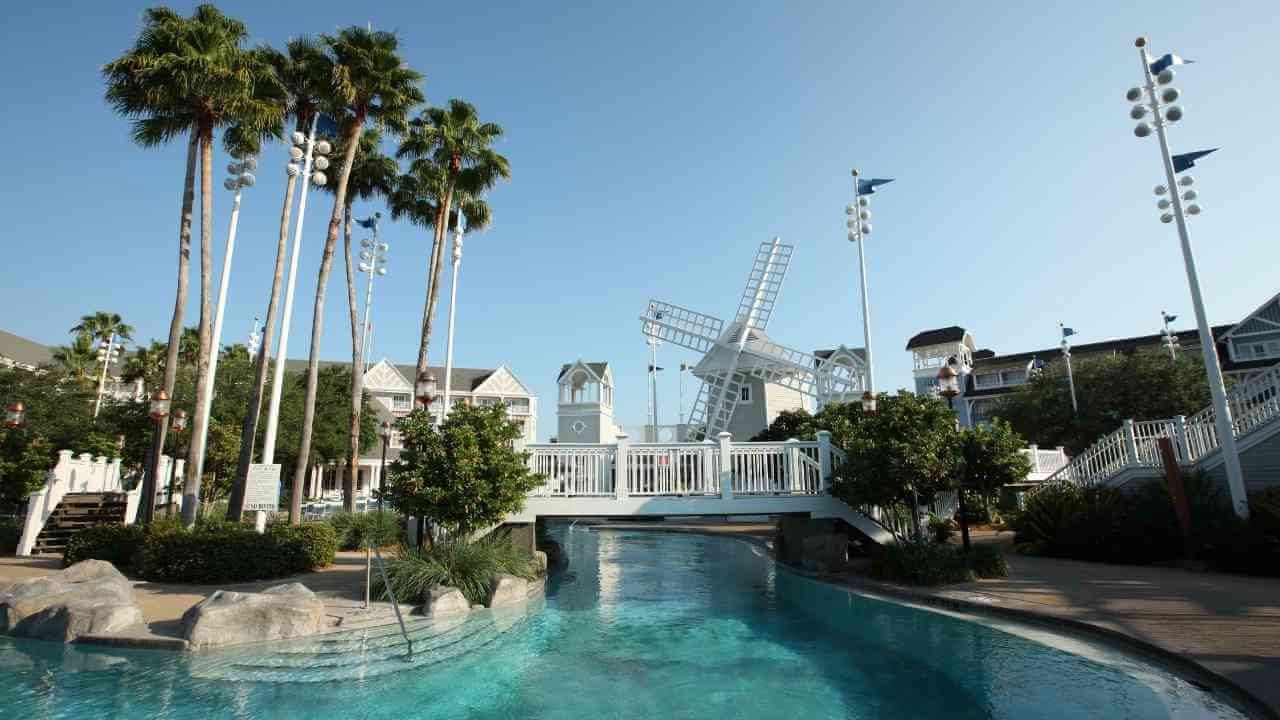 a water park with palm trees and a windmill