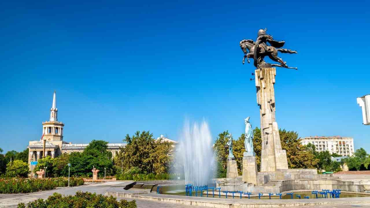 a statue of a person on horseback in front of a fountain