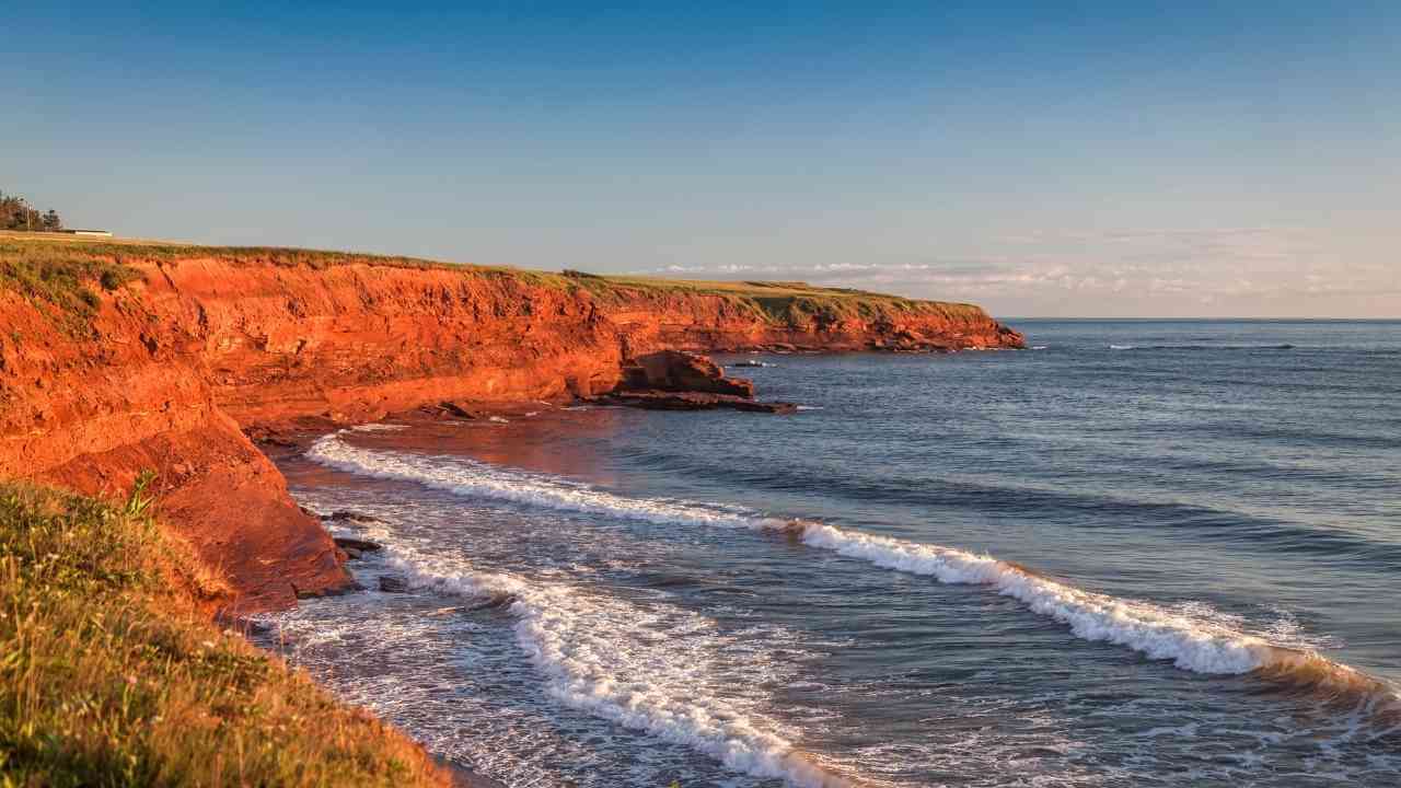 the red cliffs of cape breton at sunset