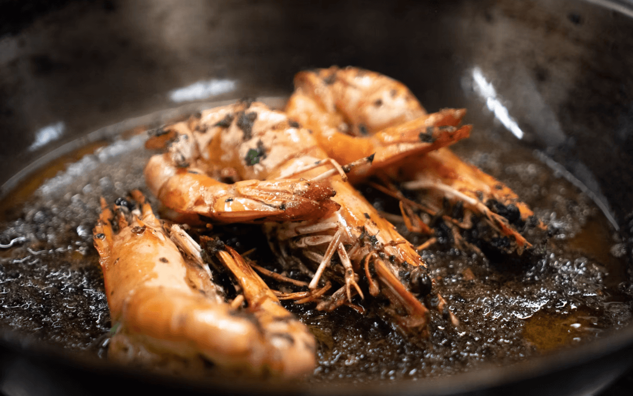 Shrimp cooking in a cast iron pan