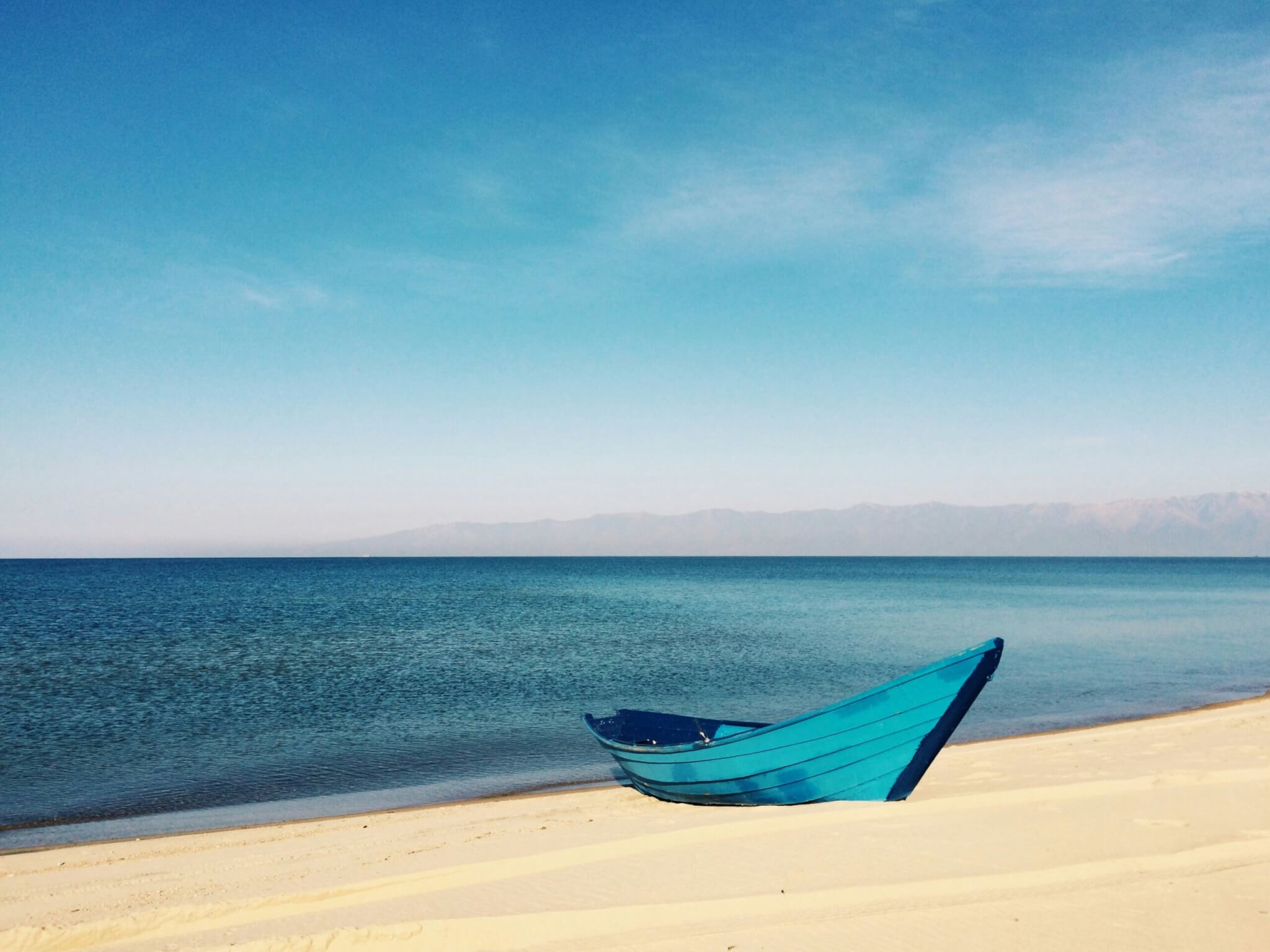 blue boat on a beach