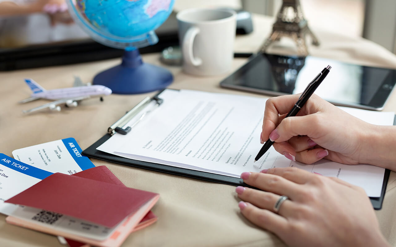 Woman signing travel documents