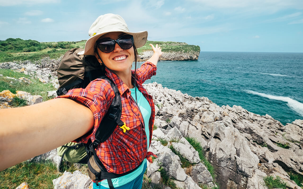 Woman taking a selfie near a shore