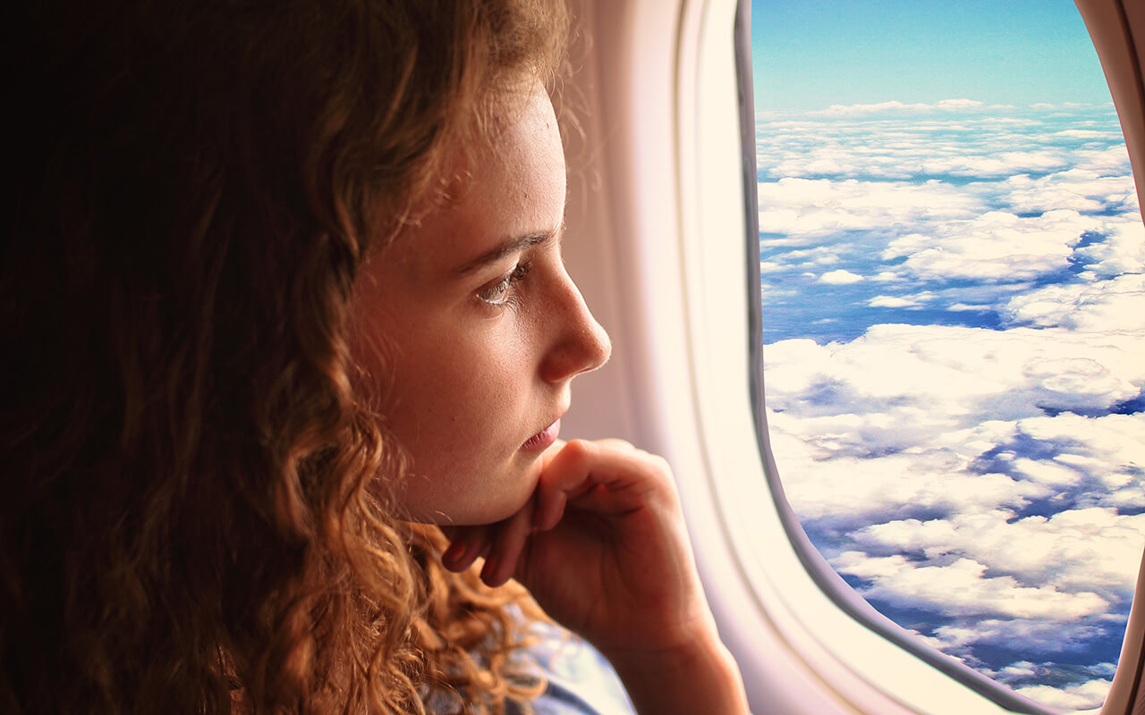 Woman looking out of airplane window