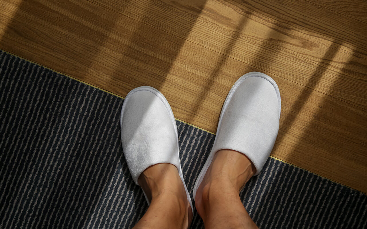 Hotel room floor and slippers