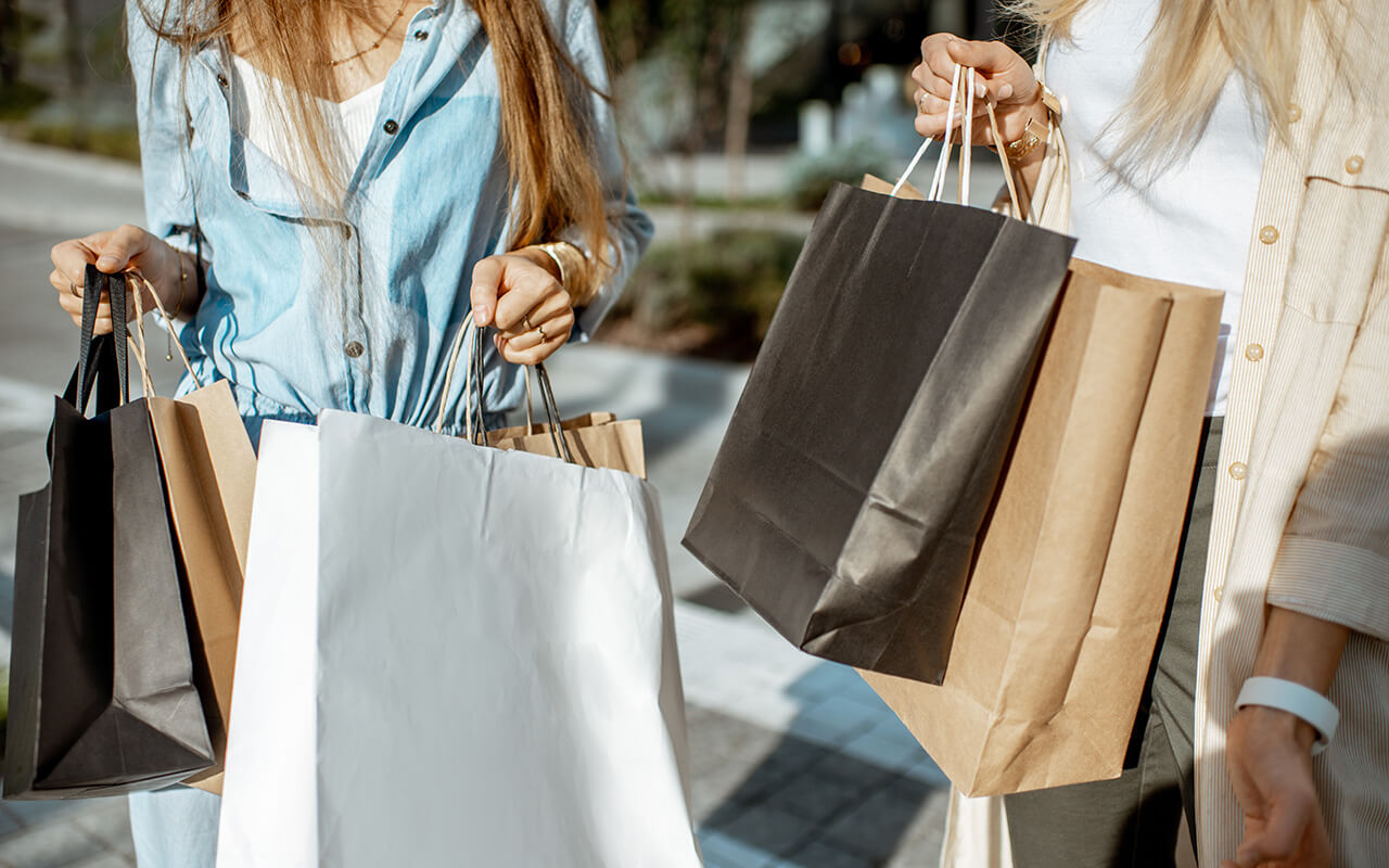 Two women with several shopping bags