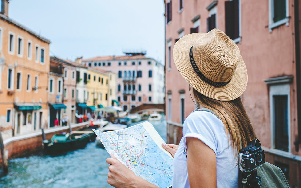 Tourist looking up from a map