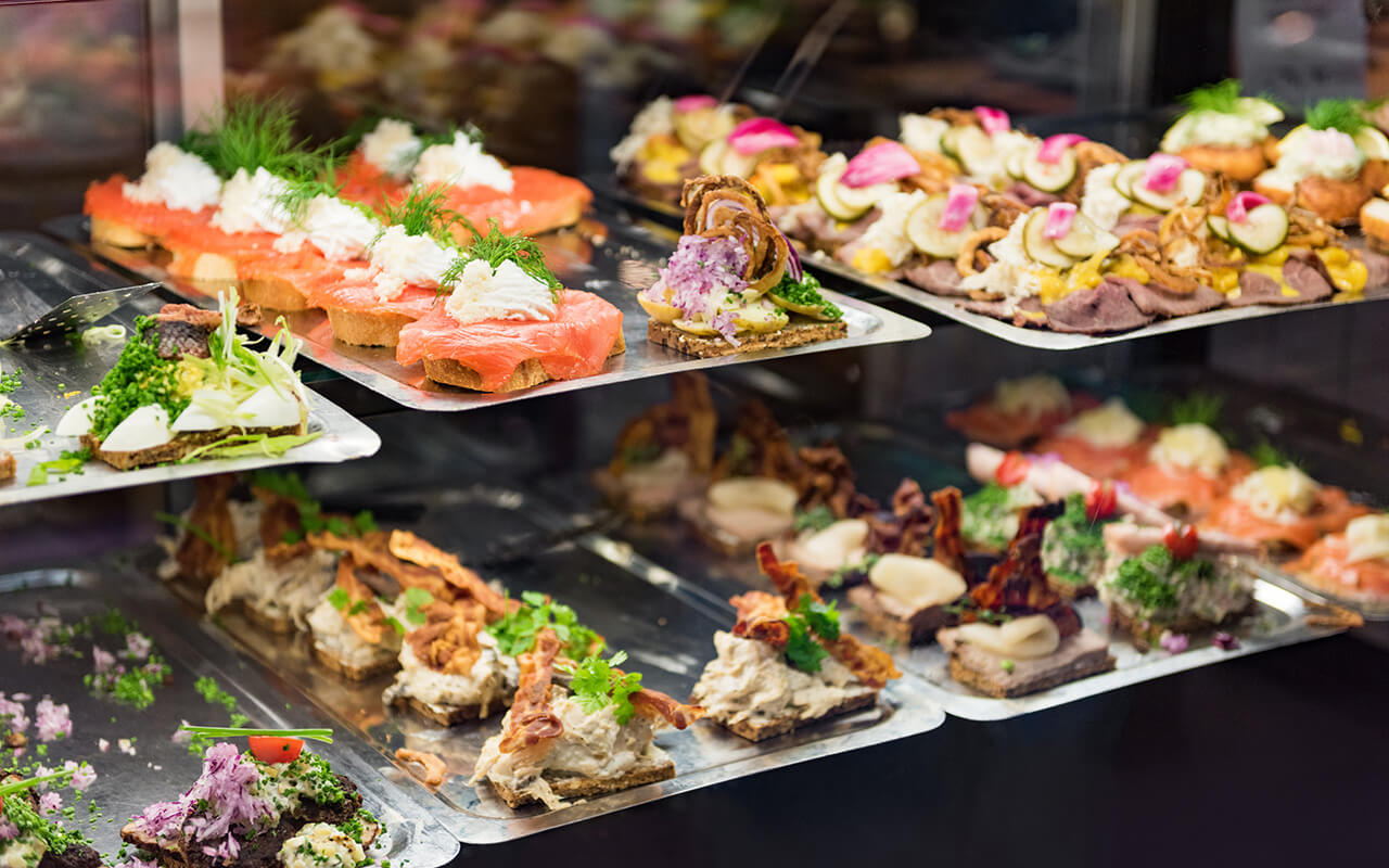 Danish smorrebrod traditional open sandwich at Copenhagen food market store. 