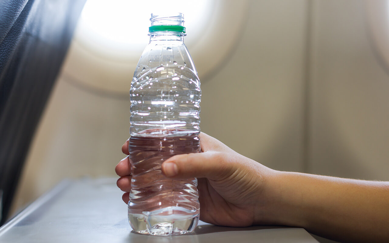 Water bottle on airplane tray