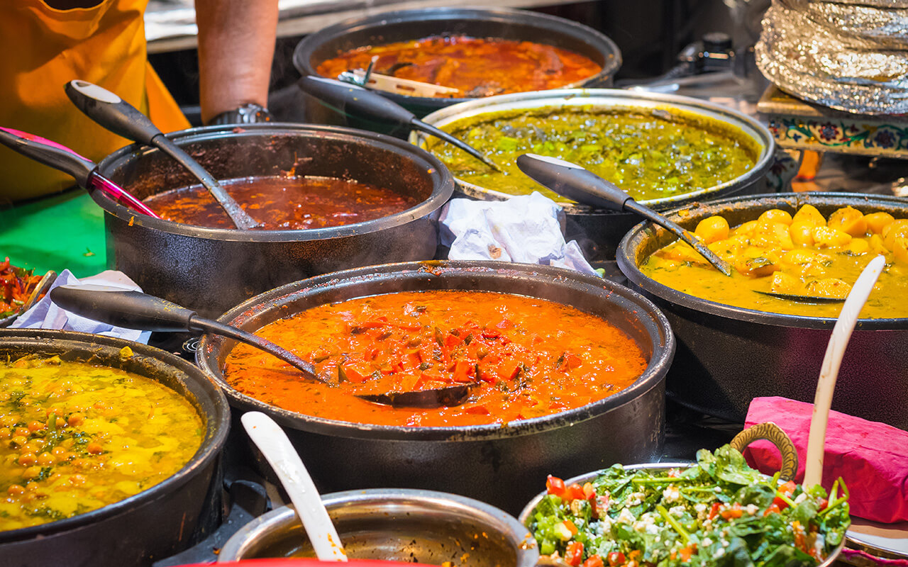 A variety of curries on display at Brick Lane Market in London