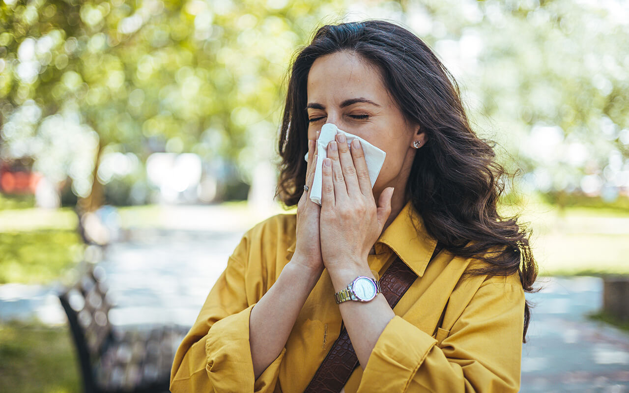 woman blowing her nose