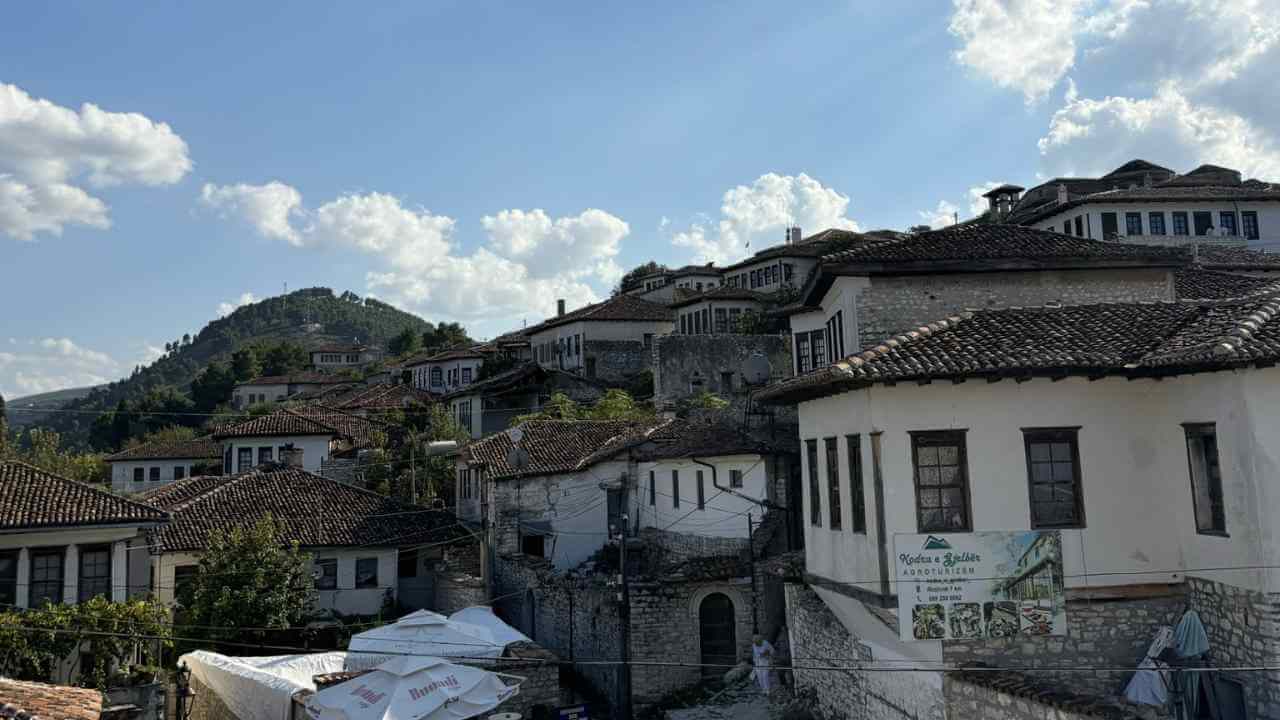 an old town with many buildings on top of a hill