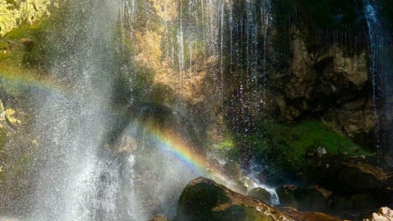 a waterfall with a rainbow in the middle of it