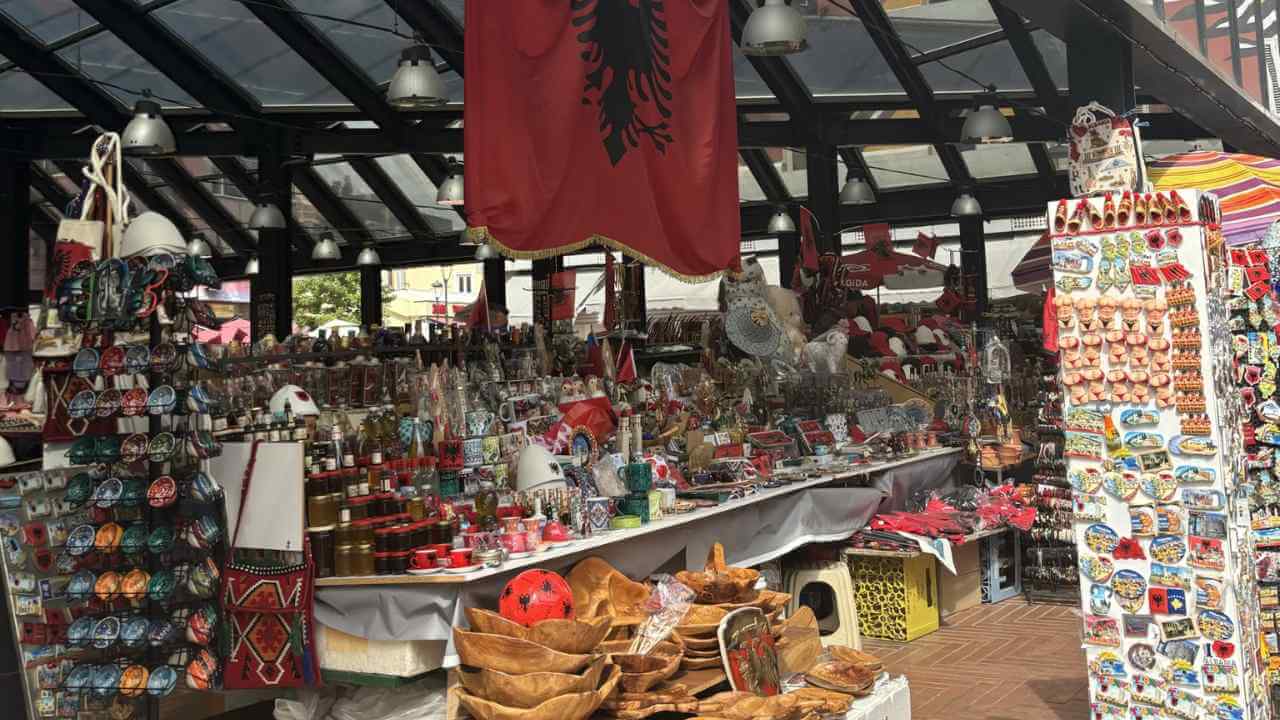 an outdoor market with lots of souvenirs and flags