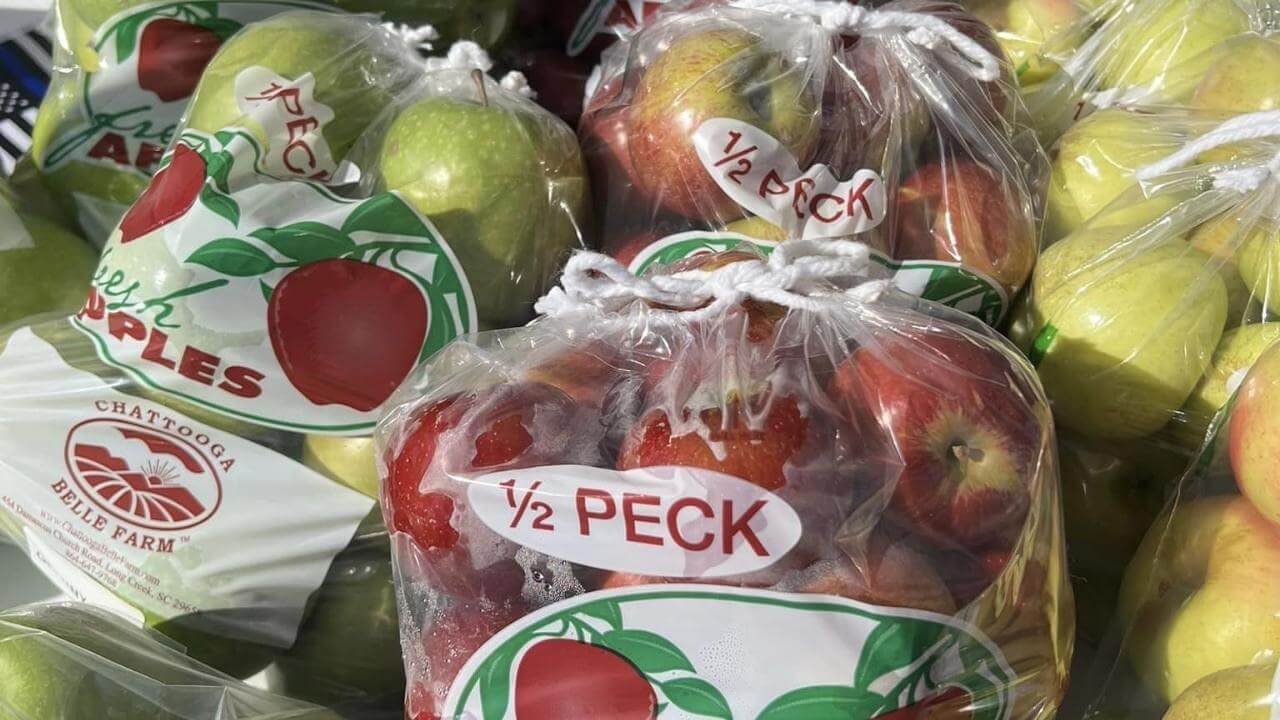 Several bags of apples are sitting on a table