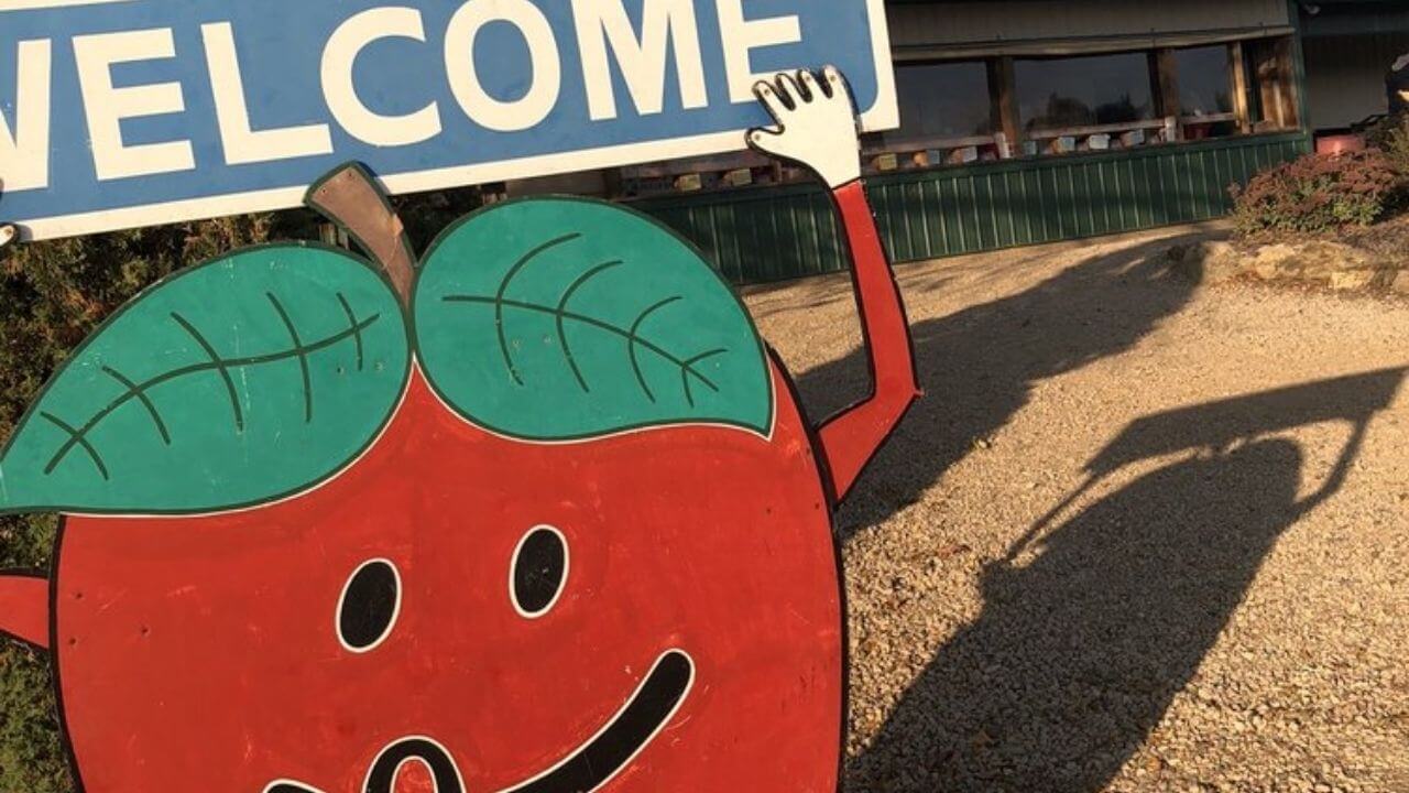 an apple with a welcome sign in front of it