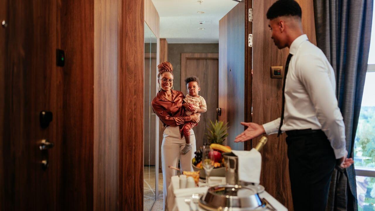 Two people standing in front of a hotel room