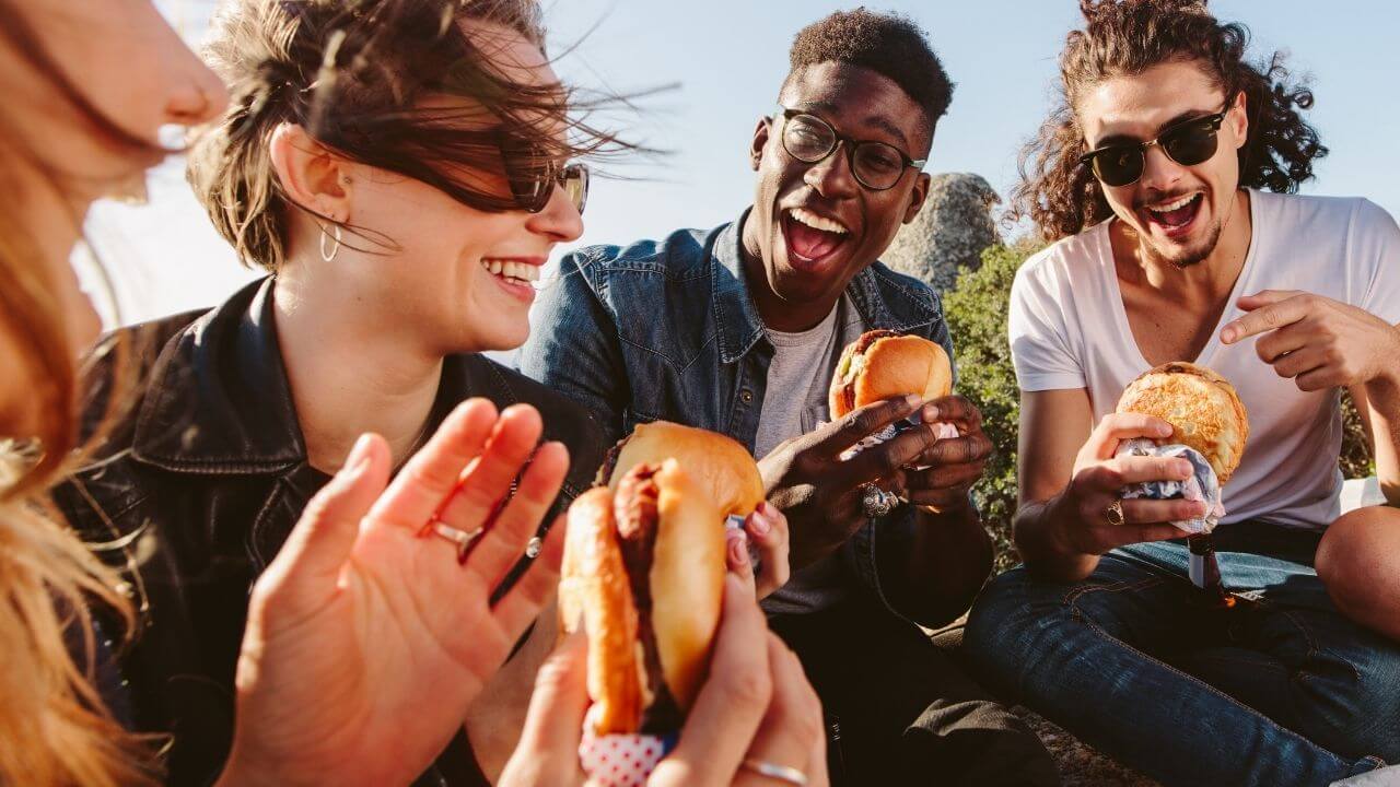 a group of people eating hamburgers together