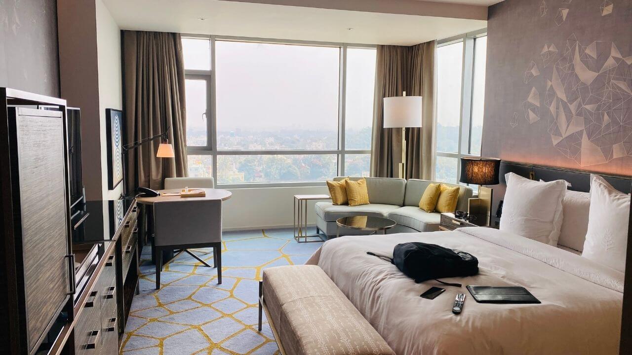 a hotel room with a large bed and a view of the city