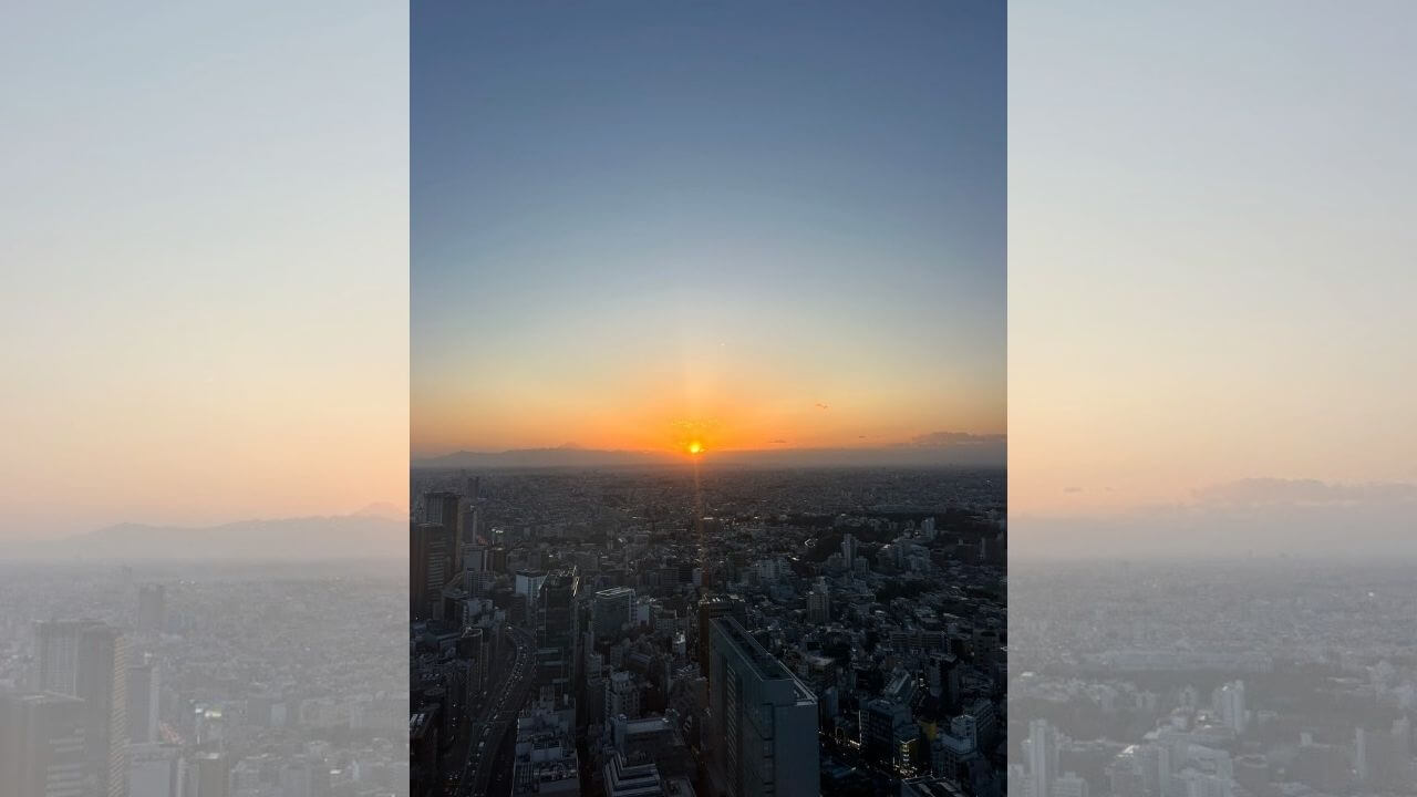 the sun setting over the city of tokyo, japan