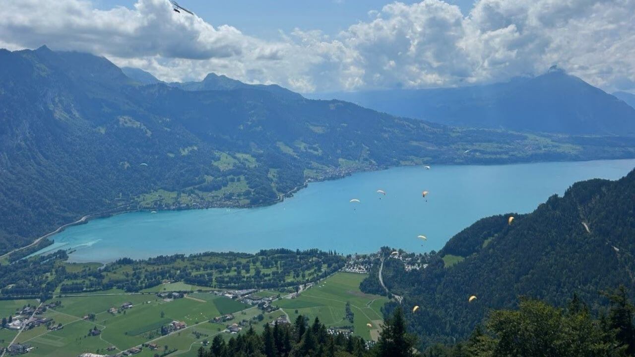 the view from the top of a mountain overlooking a lake