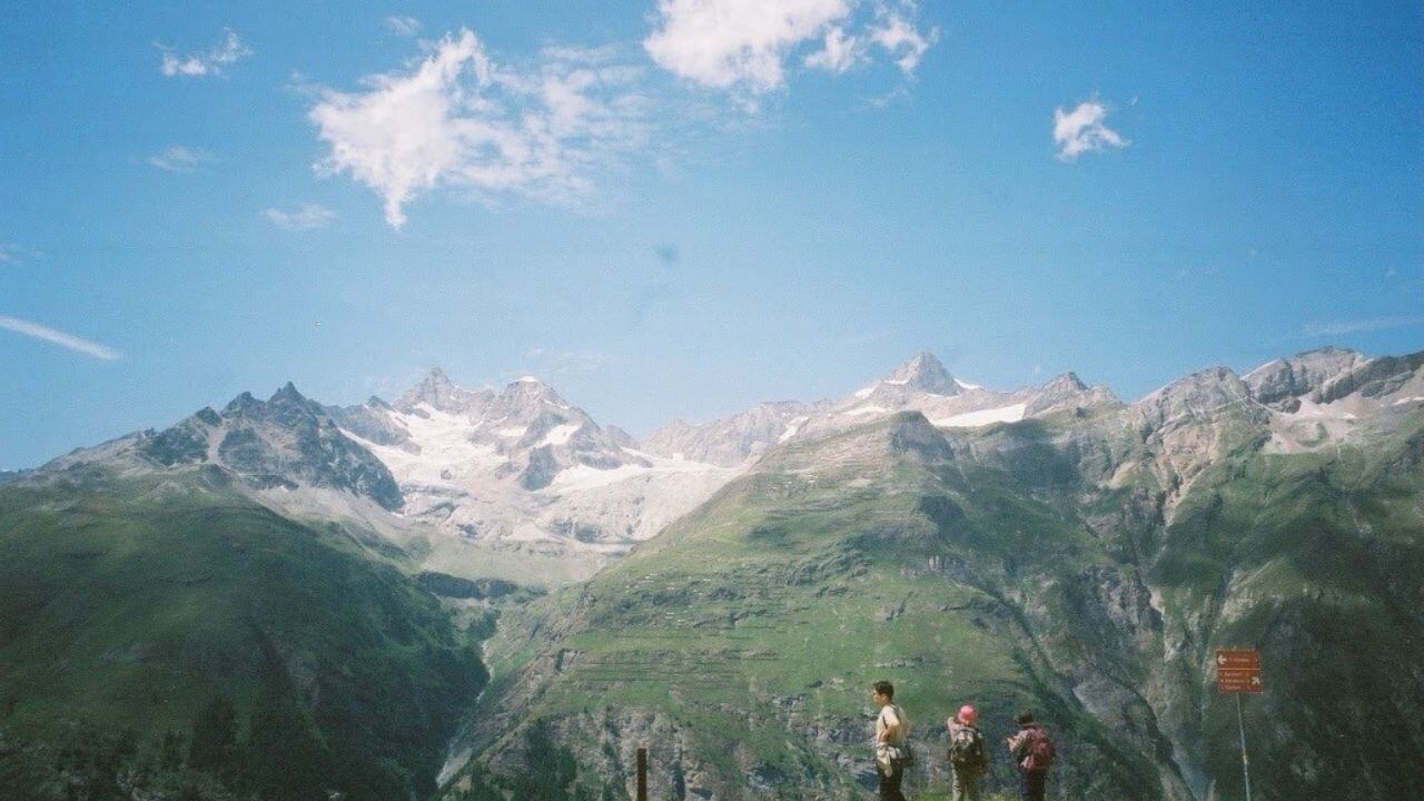 a group of people standing on the side of a mountain