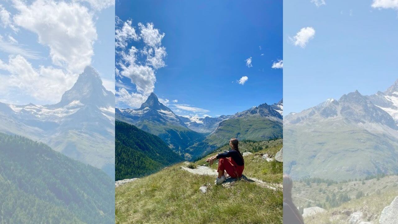 a person sitting on top of a mountain overlooking the matterhorn