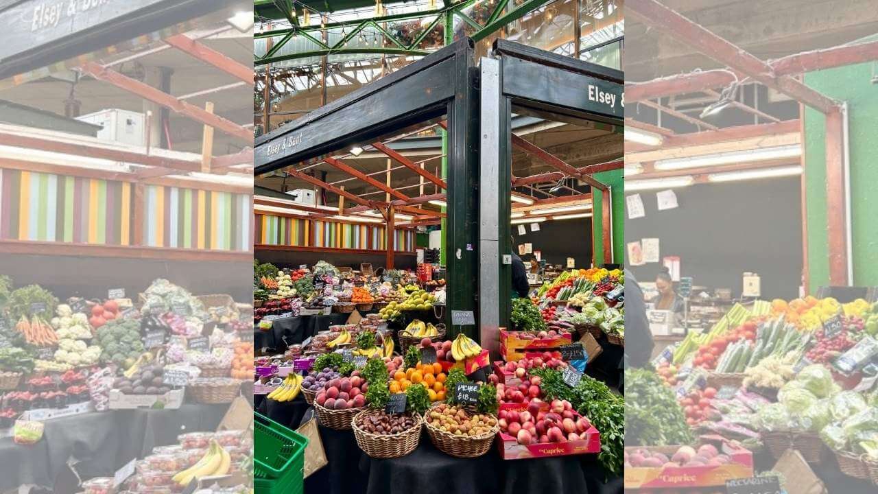 an indoor market with lots of fresh fruit and vegetables