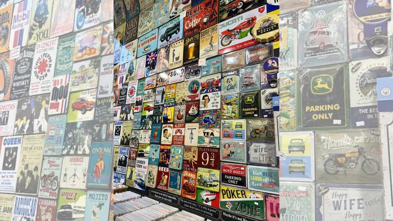 many different types of posters are displayed on the wall