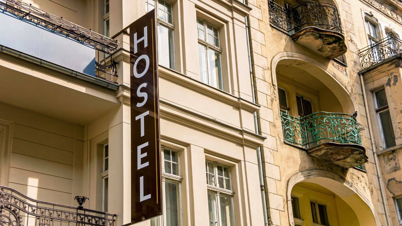 a building with balconies and a sign that says hostel