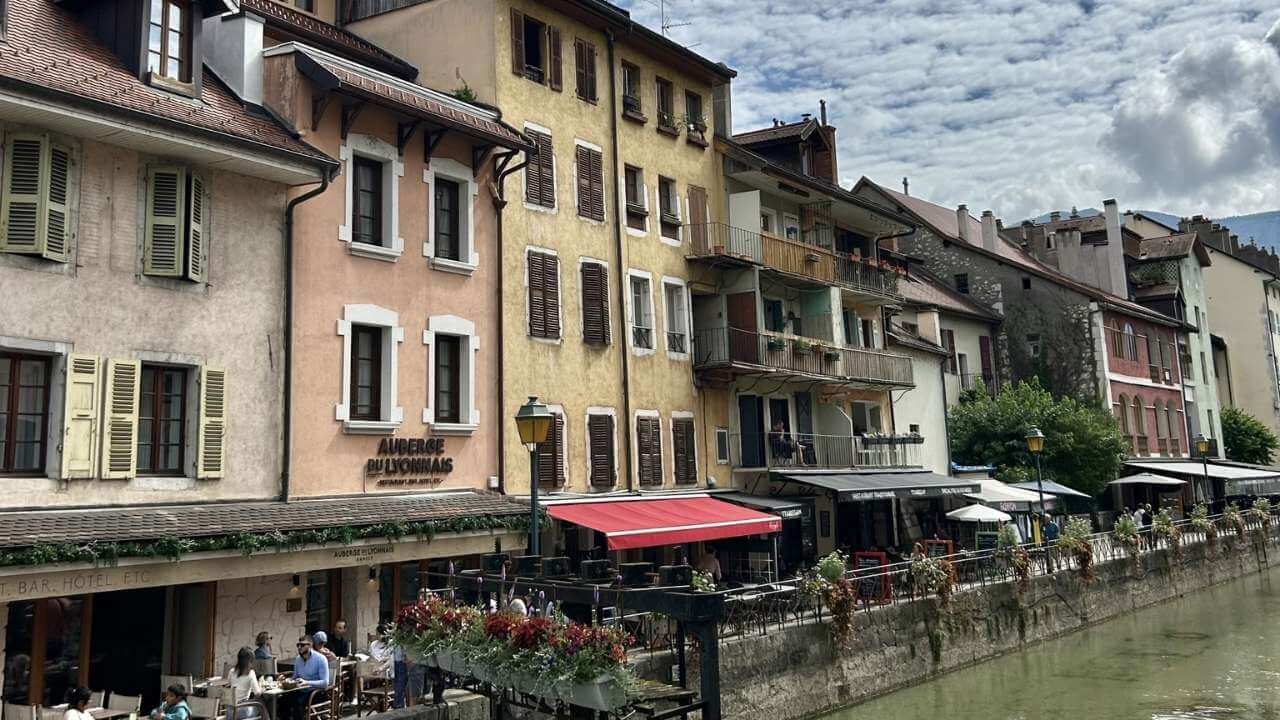 a river in front of a row of buildings in an european city