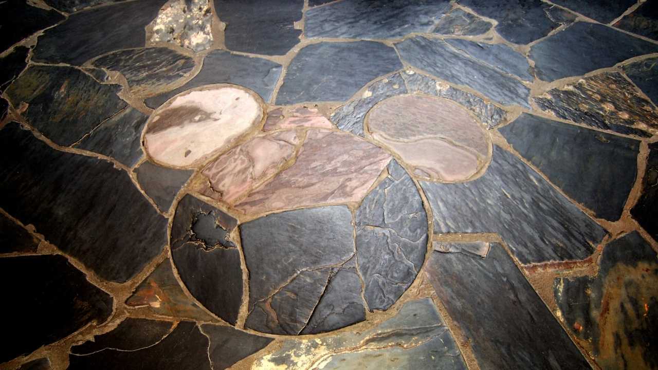 a close up of a stone floor with a bear on it