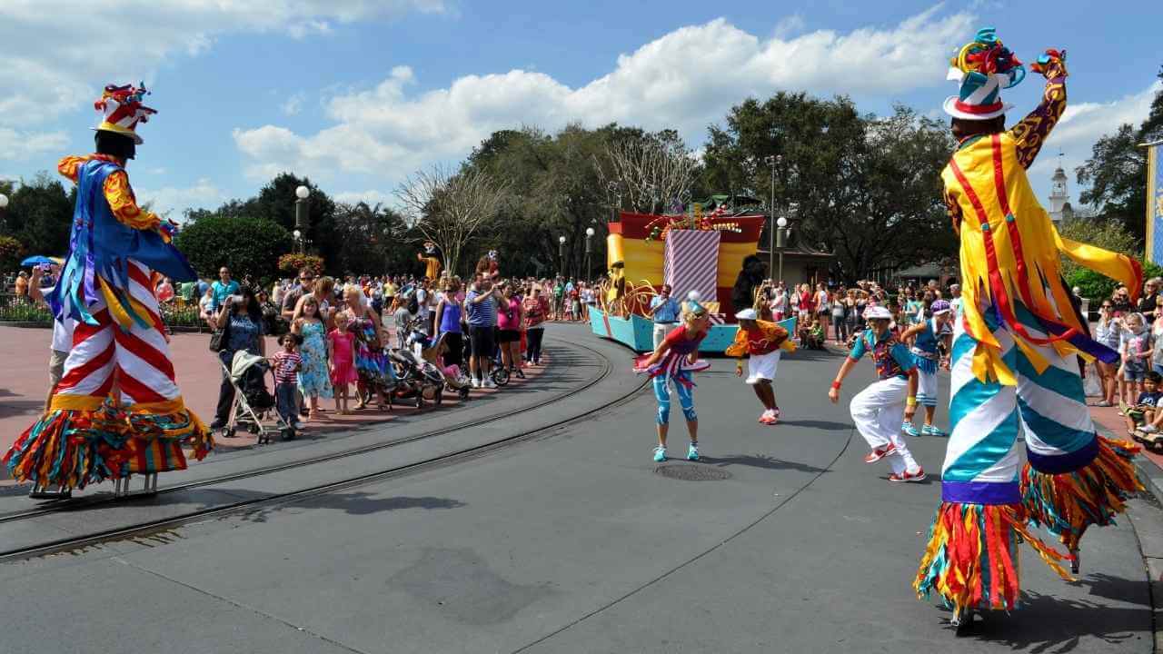 a group of people dressed up in colorful costumes on a street