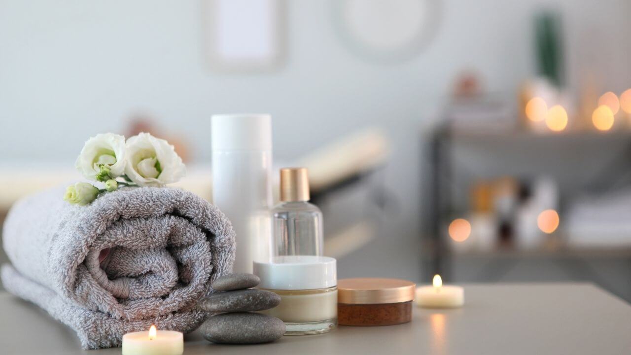 towels and candles on a table in a spa room