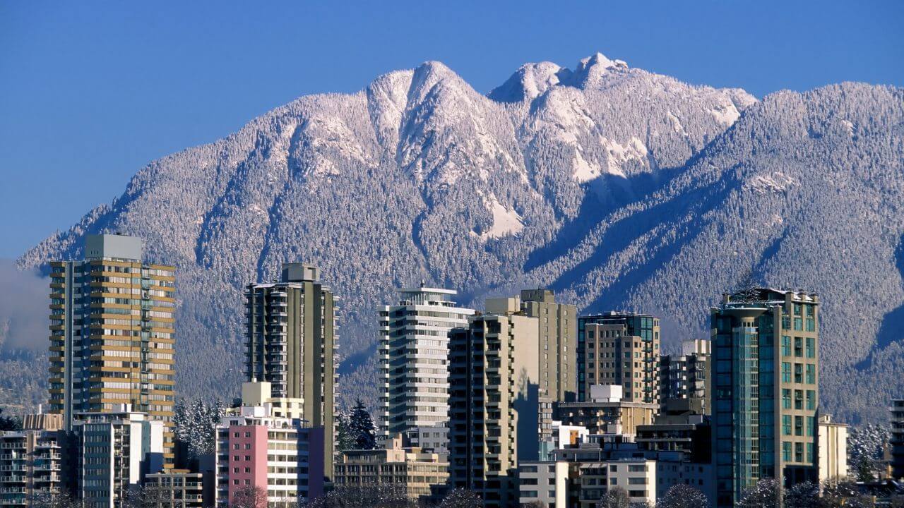 the city of vancouver with mountains in the background