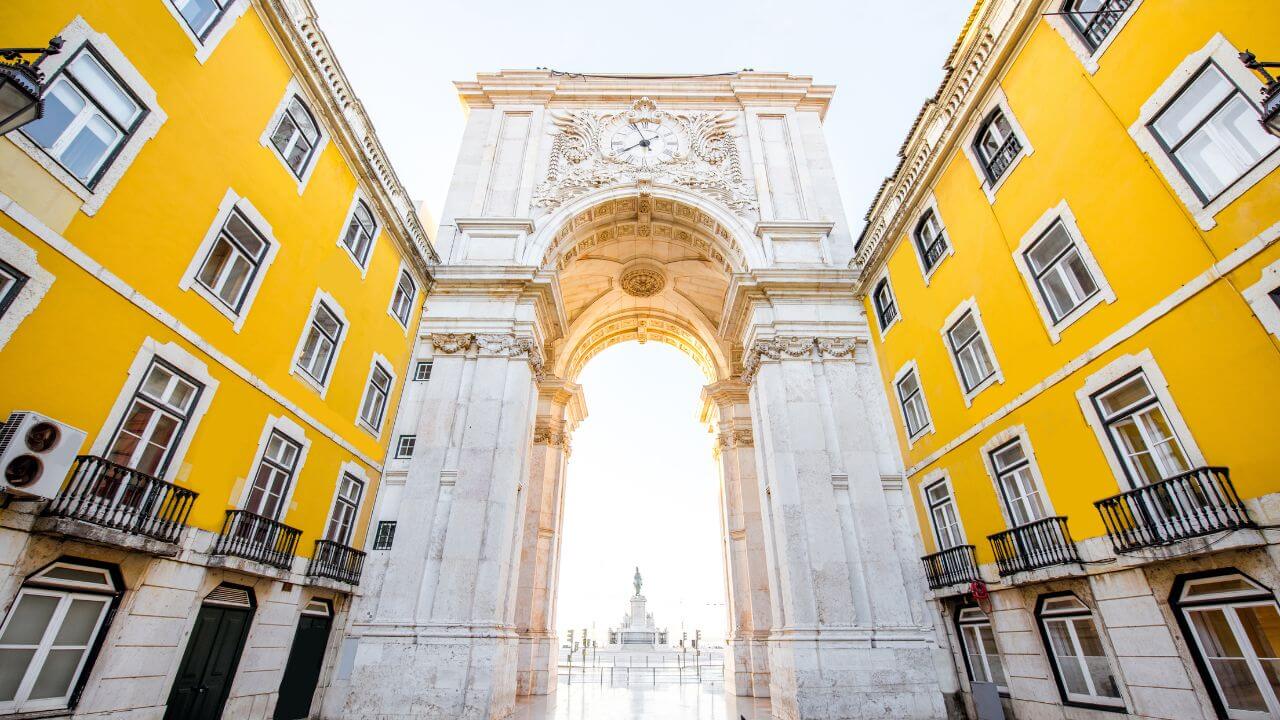 a yellow building is surrounded by white and yellow buildings