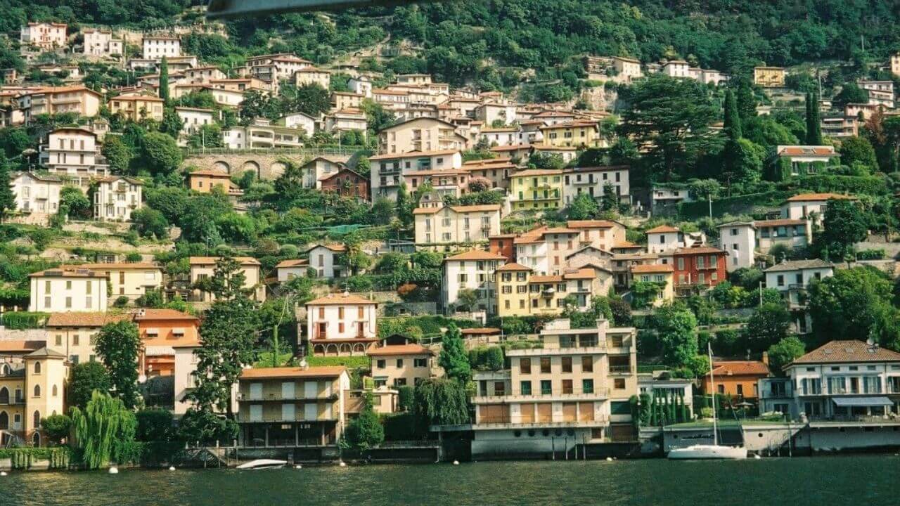 a view of a town on the shore of a lake