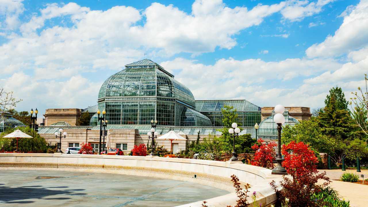 a large building with a fountain in front of it