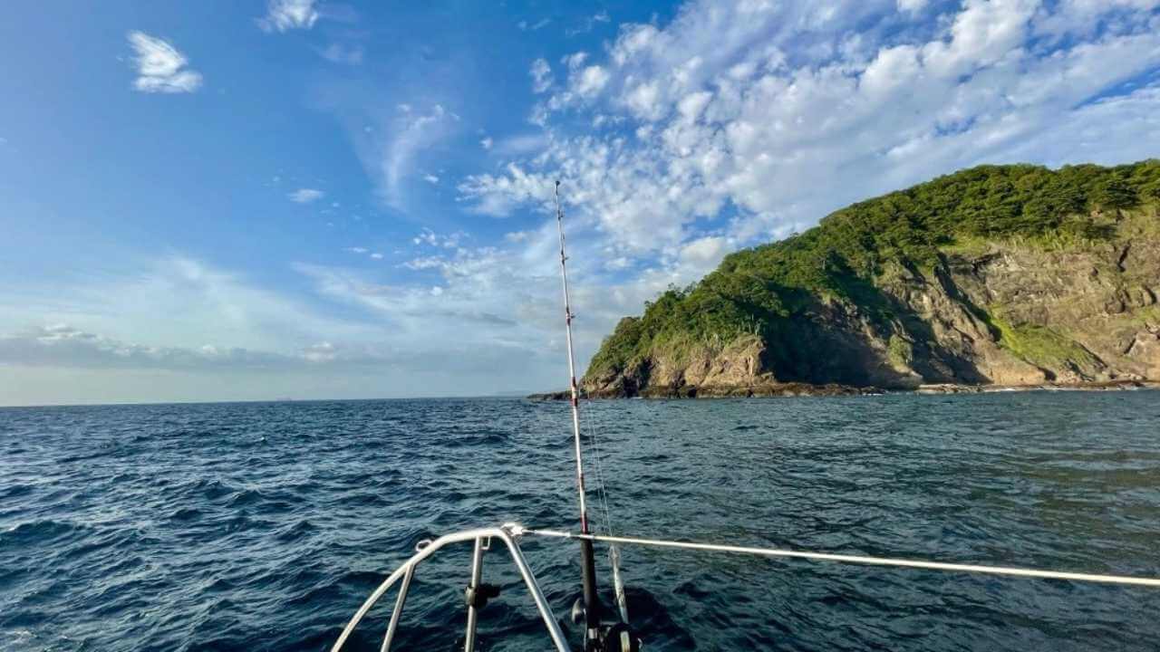 the view from the bow of a boat on the ocean