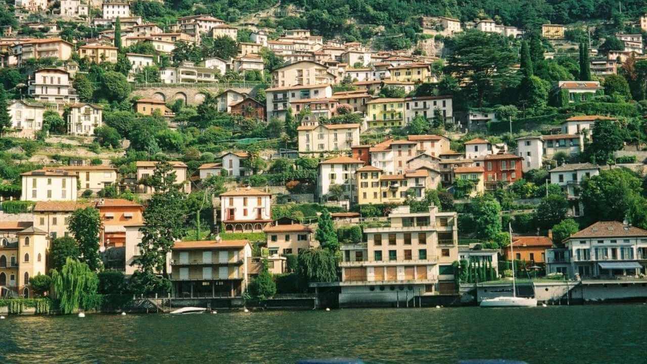 a view of a town on the shore of lake como, italy