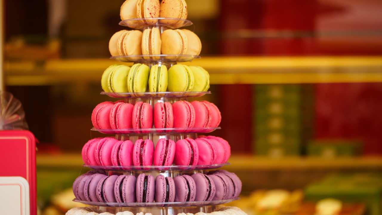 a tower of colorful macarons on display in a store