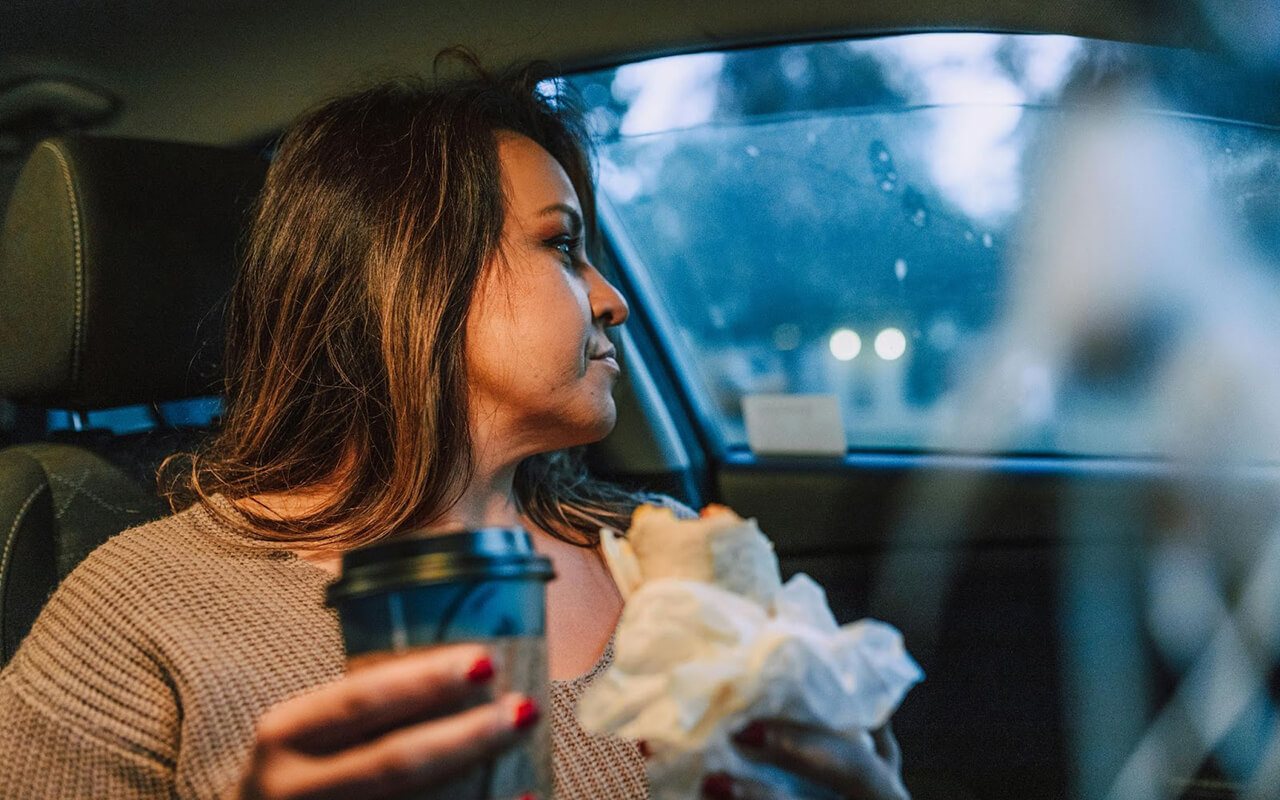 Woman with food in a car