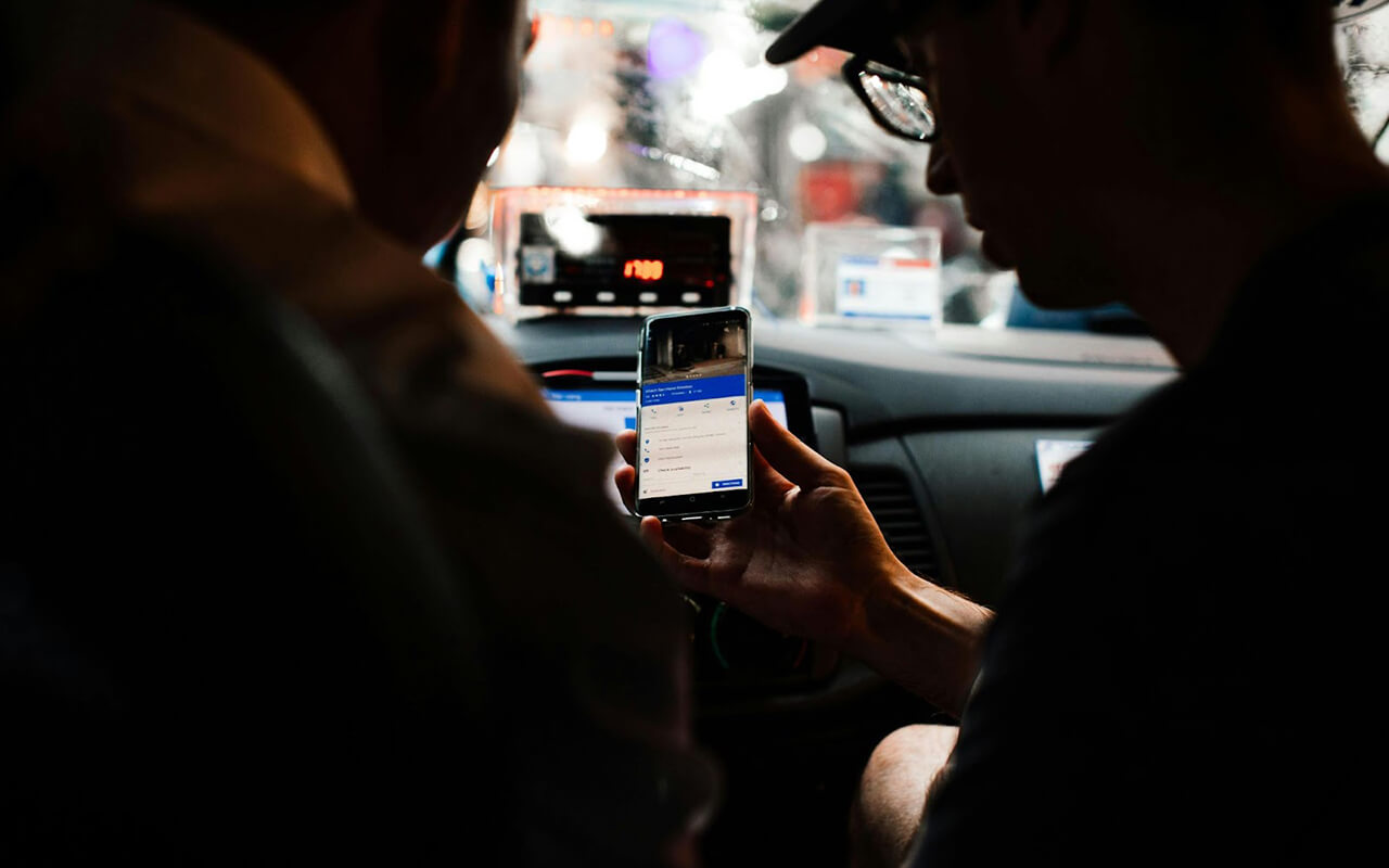 Passenger showing their phone to the driver