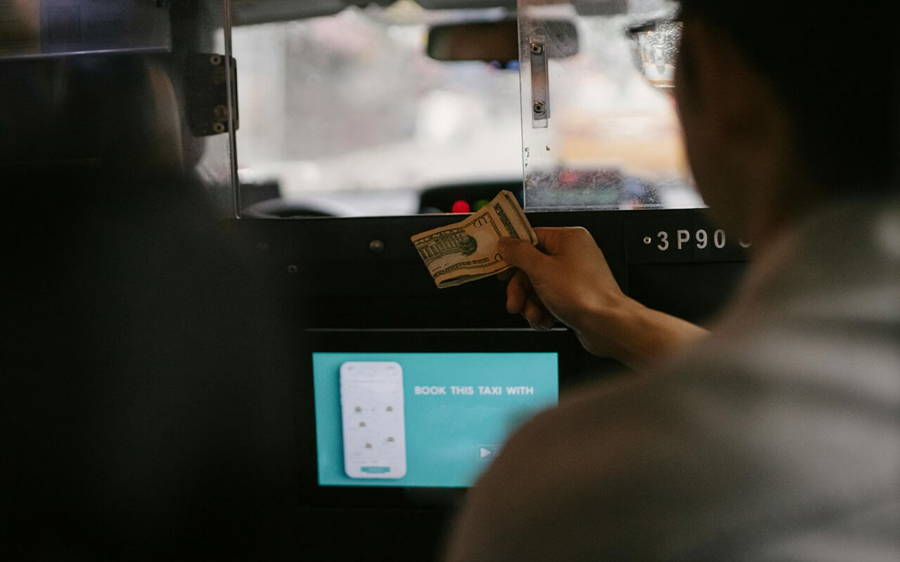 Passenger tipping a taxi driver